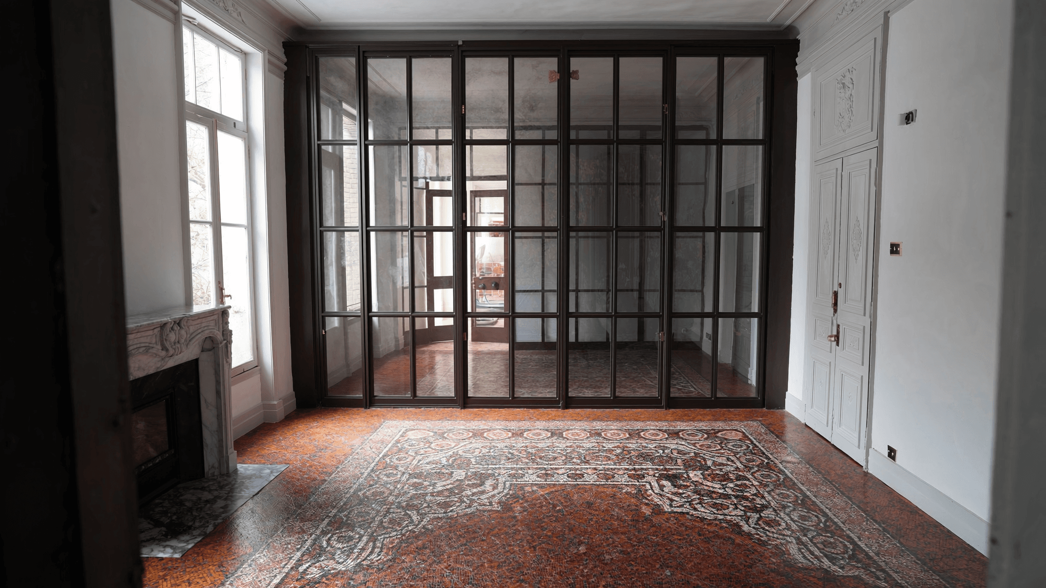 Verrière atelier appartement haussmannien XIXe Paris 2e Vivienne — profil acier T 40 × 40 mm S235JR patine bronze antique sur mesure par Yann + laiton fait main fonderie Bois-d'Arcy + verre clair feuilleté Saint-Gobain Diamant 8+8 mm — ABF Galeries XIXe accepté 1ère instruction